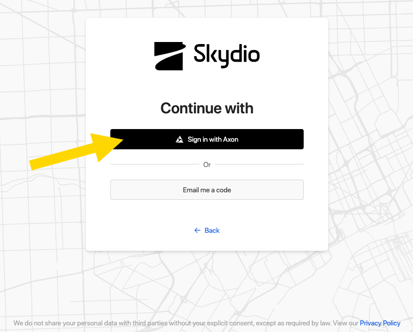 A yellow arrow pointing to the Sign in with Axon button on the Skydio Cloud website