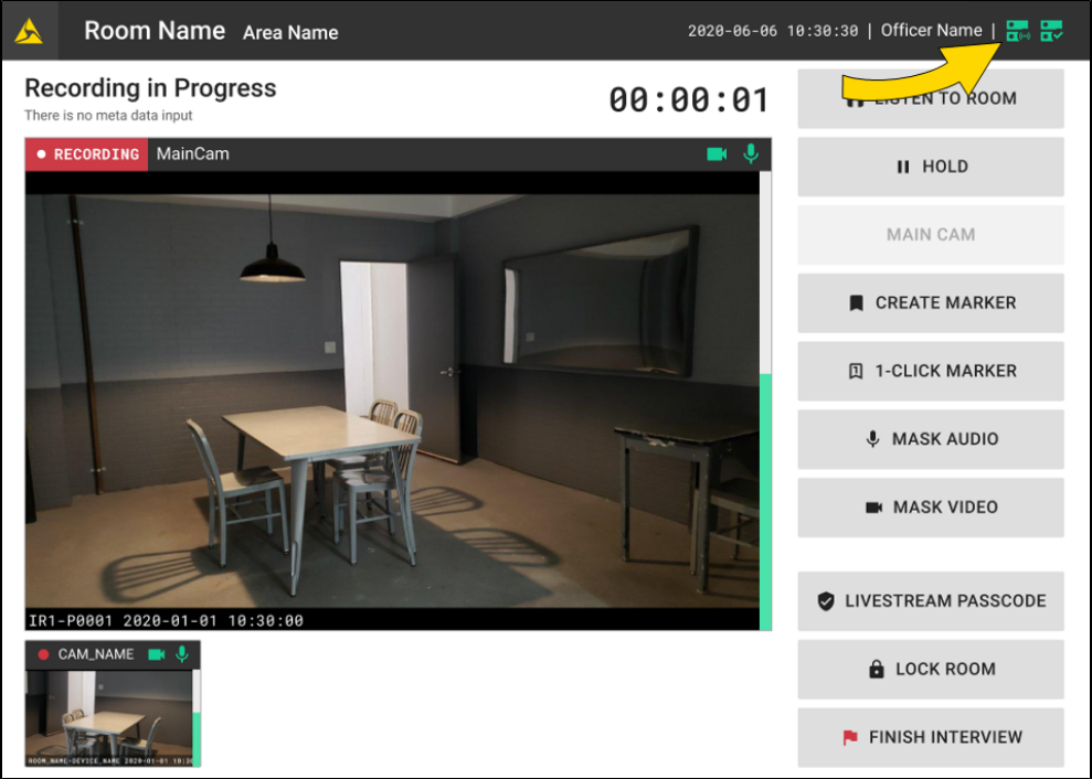 The image shows a video recording interface with a live camera view of an interview room containing a table and chairs in the center, a door on the back wall, and a wall mounted screen on the right. At the top, a status bar indicates recording in progress with a timer, while the main video feed is displayed in the center and a smaller thumbnail preview appears below it on the left. On the right side, a vertical panel of controls is shown, and a yellow arrow highlights icons in the top right corner of the screen.