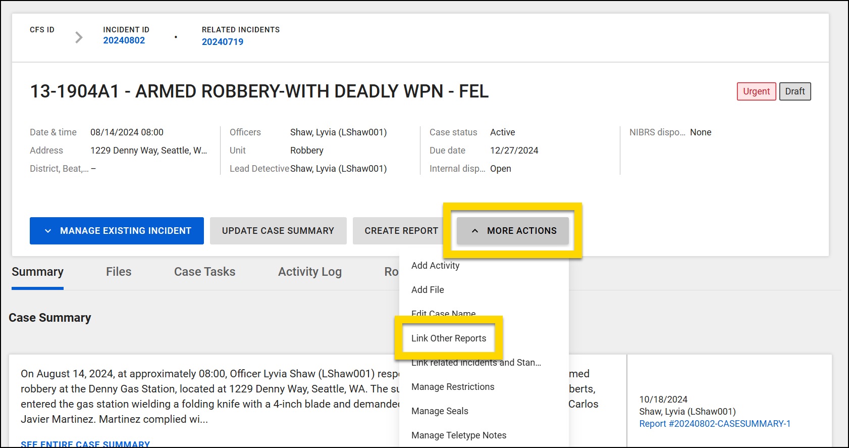 The image displays the details of an incident involving an armed robbery. The More Actions menu is highlighted and expanded with the Link Other Reports option highlighted.